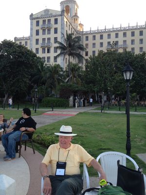 ... with the Hotel behind him